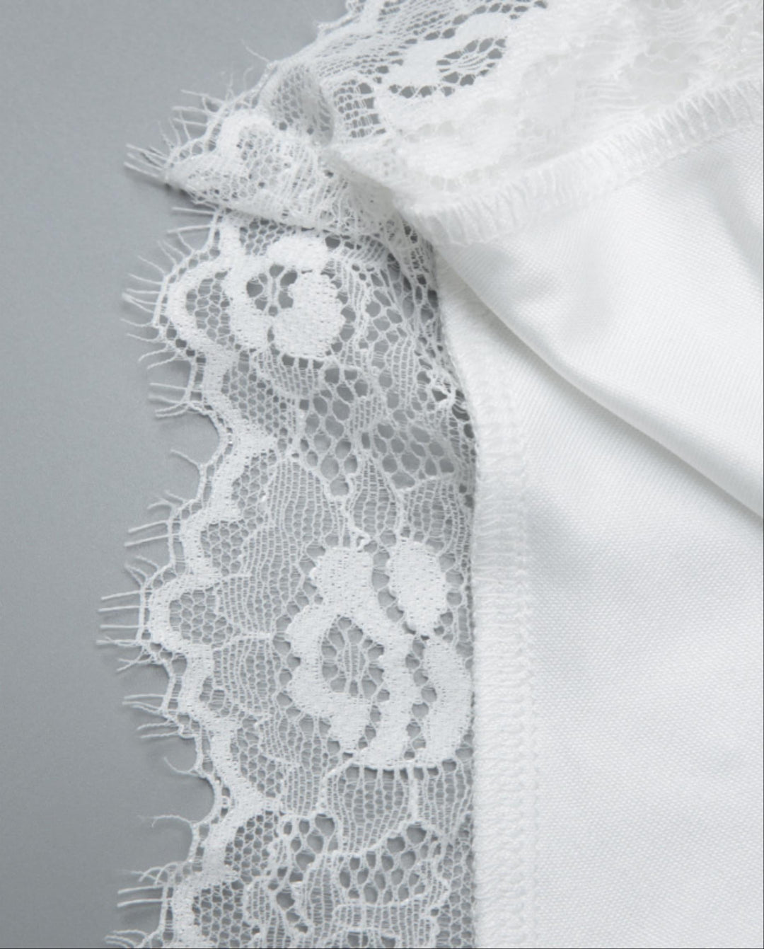 SOLACEWhite Off-Shoulder Lace Trimmed Asymmetric Hem Top
